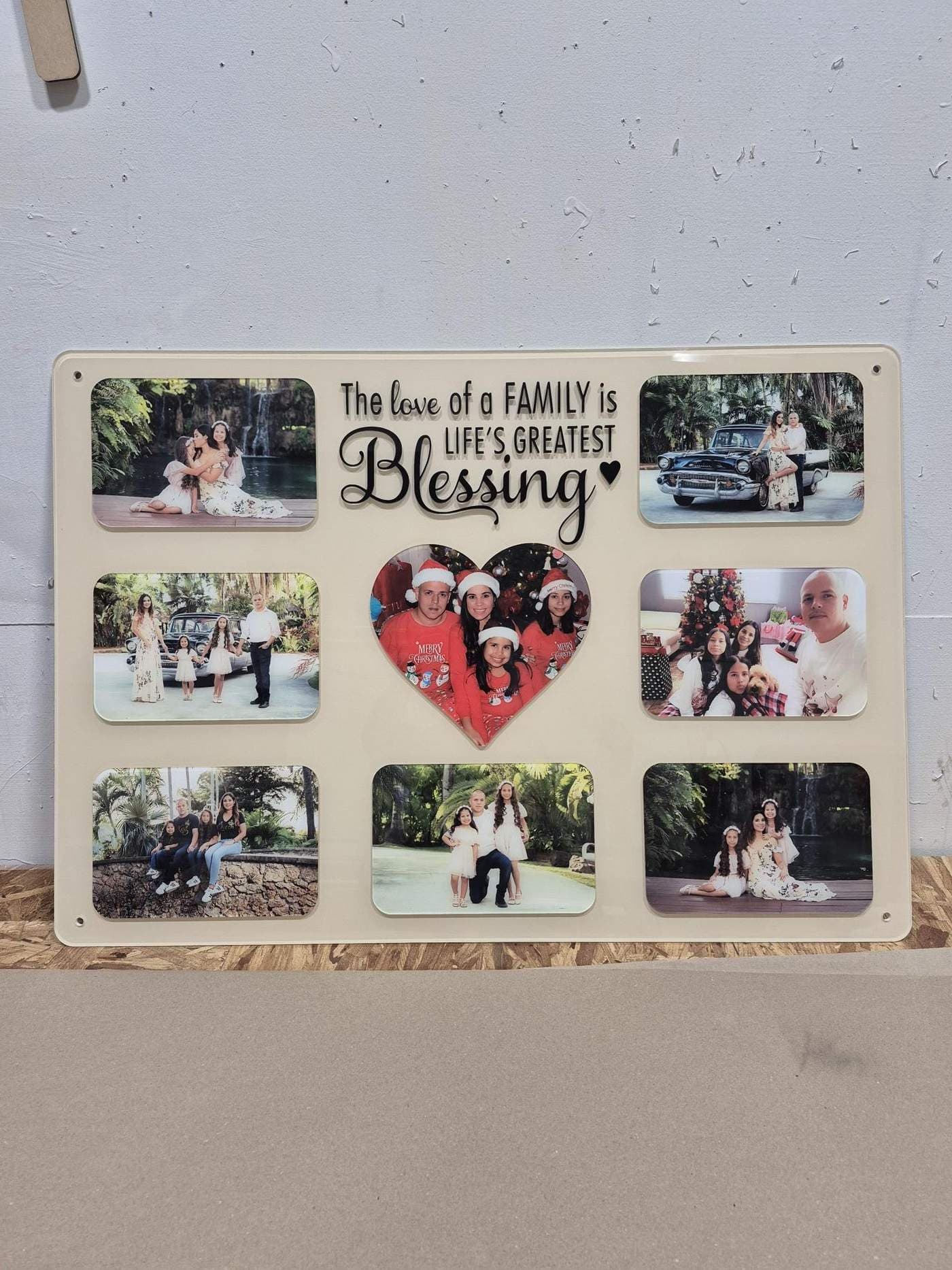 Photo collage tribute board with nine family photographs, a heart-shaped centre photo, and raised script lettering, made in Tampa